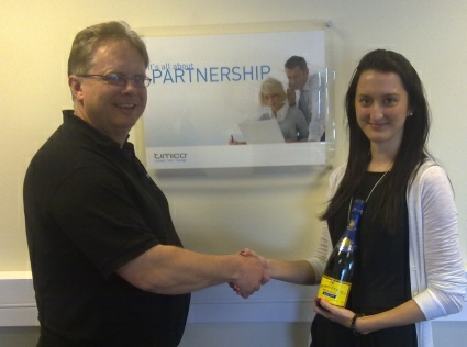 Trefor Davies presents Gemma Barsby with a bottle of champagne for passing the Cisco sales examination