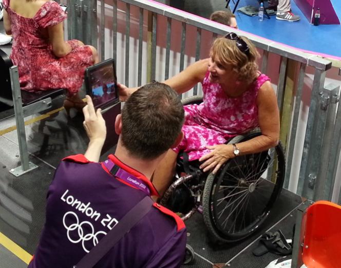 woman reviews photo taken for her by Games Maker at the mens handball semi finals