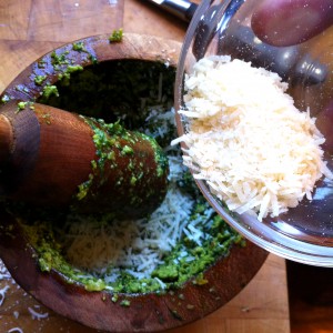9. Add freshly-grated parmesan to your oily paste and grind some more.