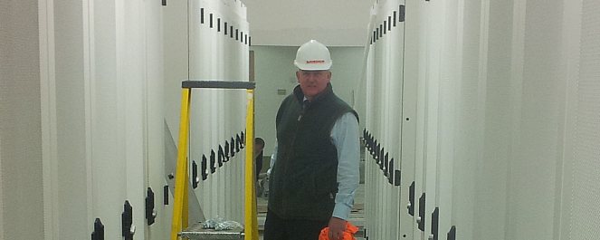 Tim Radford inspects a row of racks in the Timico data centre