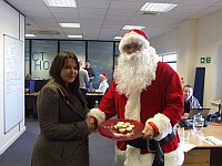 Fiona Spear - winner of the Timico mince pie competition is congratulated by Santa himself
