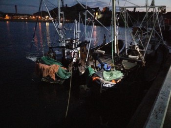 boats at night at peel breakwater